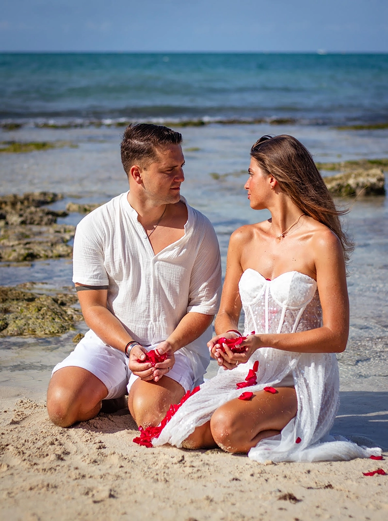 Portrait of a happy couple embracing on the beach during golden hour
