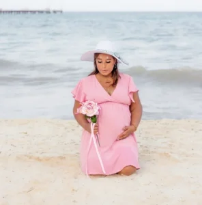 Maternity photos session on the beach in Playa del Carmen showing a glowing pregnant woman at golden hour